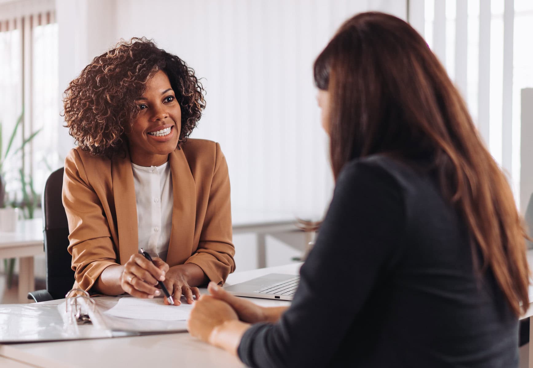 Woman consulting with a female financial manager at the bank