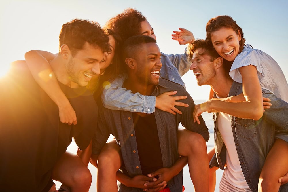 A group of friends laughing outside together