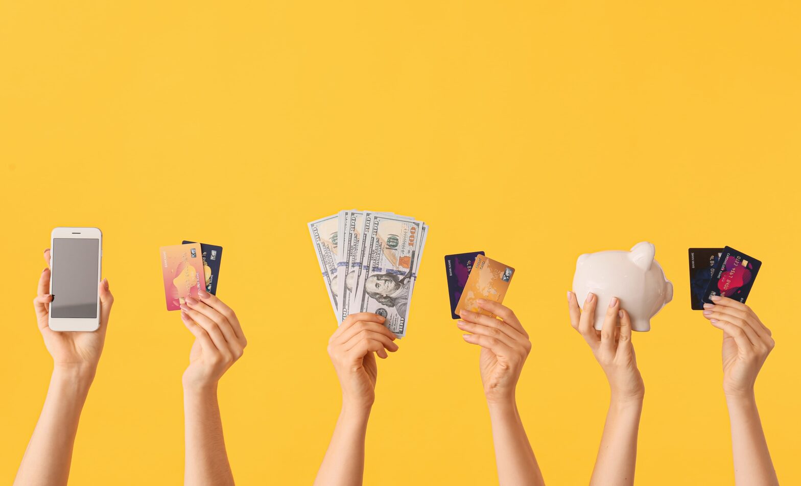 yellow background hands holding money phone bank