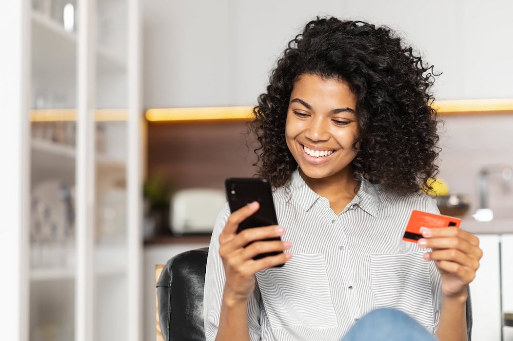 girl on phone with card